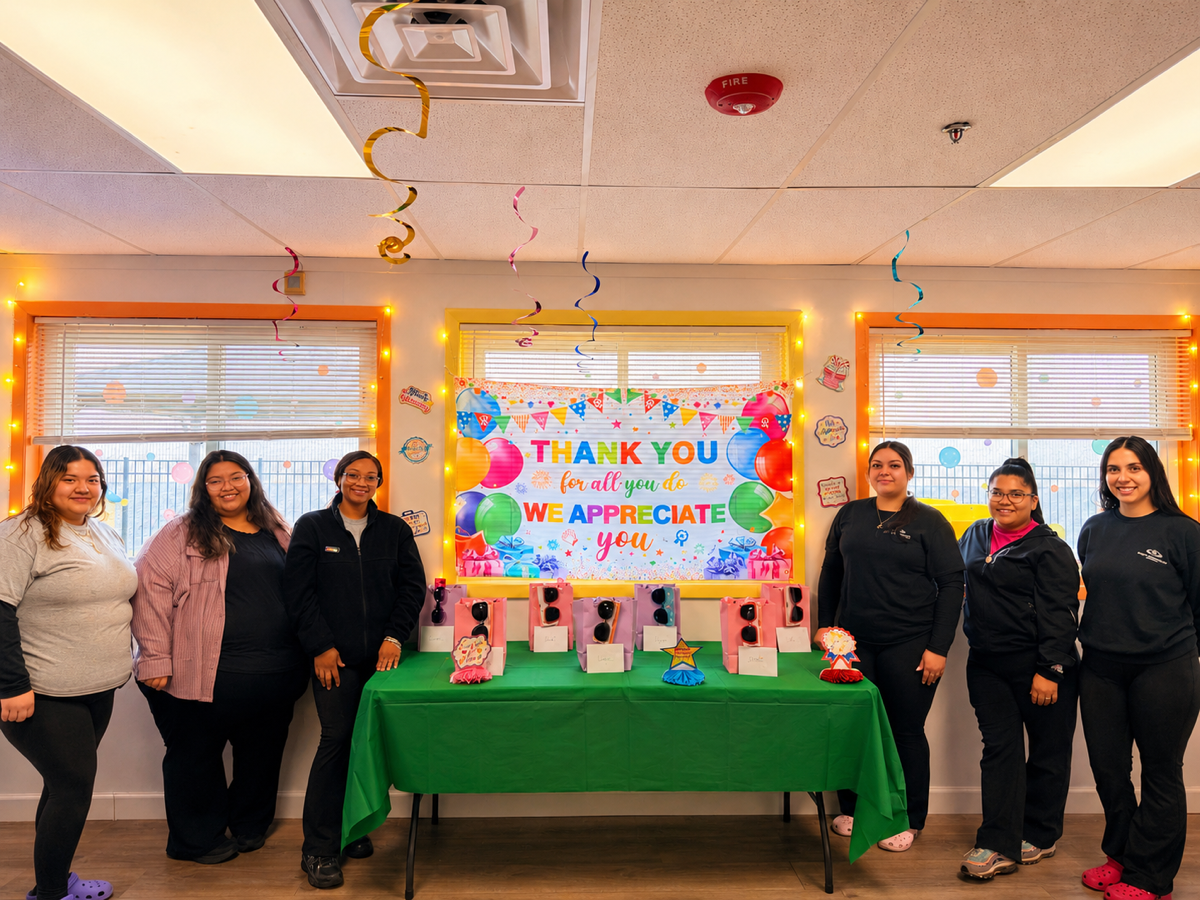 The Ogden team standing in front of the Thank You appreciation display